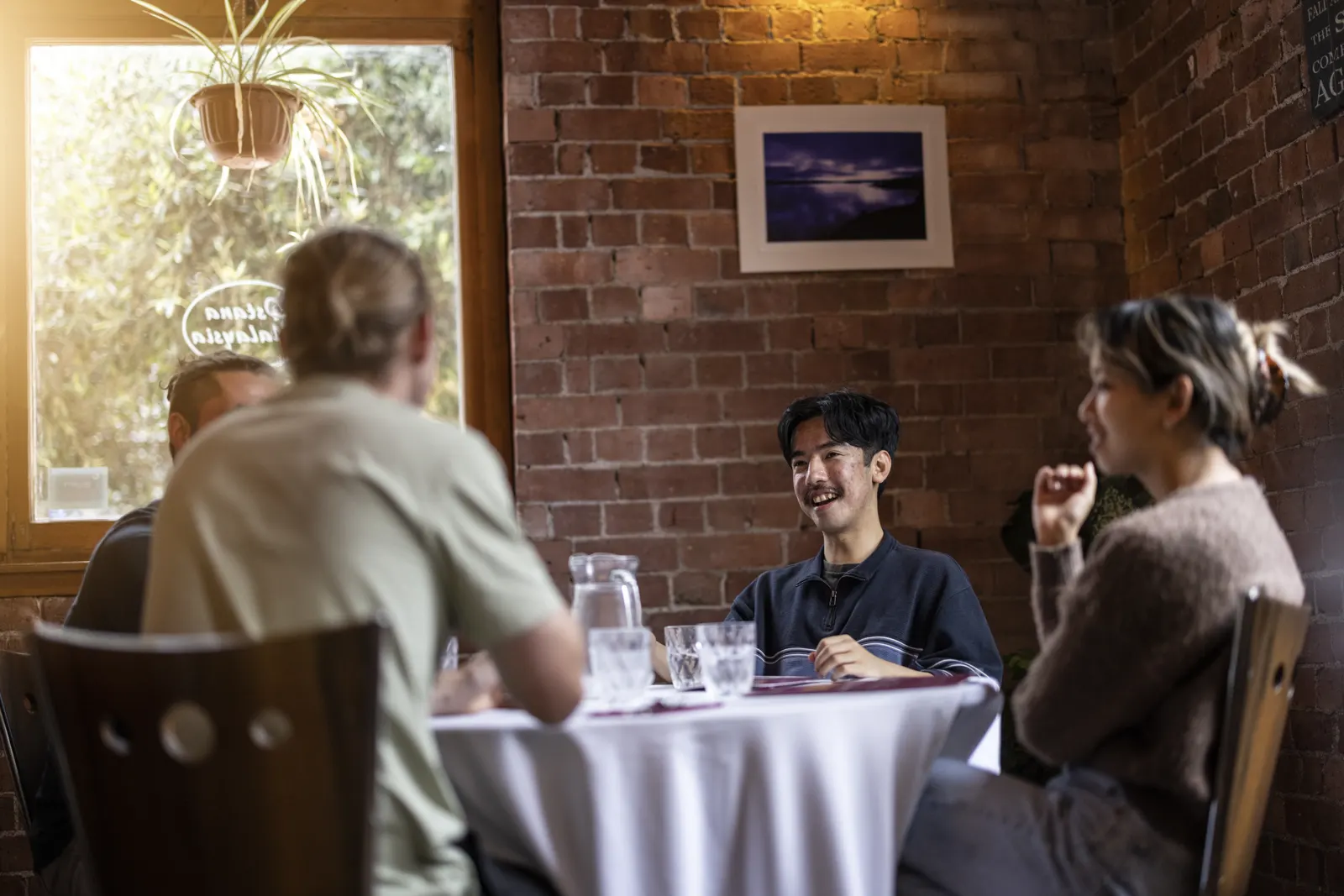 A group of friends sharing a meal at a restaurant in Wellington